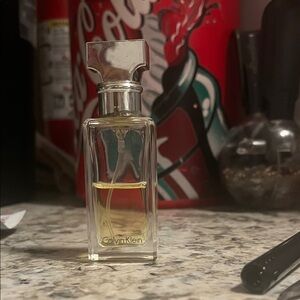 eternity Calvin Klein Clear Glass Perfume with Silver Cap. HALF FULL